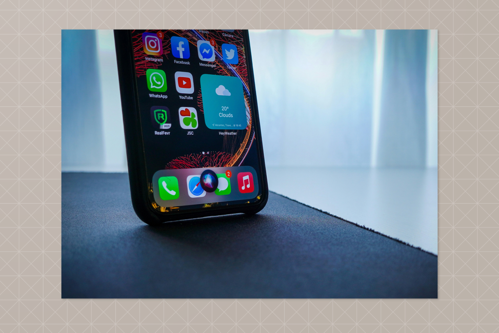 Close-up of a smartphone displaying a home screen with various apps including Instagram, Facebook, WhatsApp, and a weather widget showing “20° Clouds.”