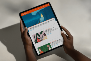 A laptop displays an Edutopia article titled “5 Essential Tech Talks to Have With Students,” illustrated with a classroom raft scene navigating a digital flood. On the right, a visible comment section shows reader input and engagement.