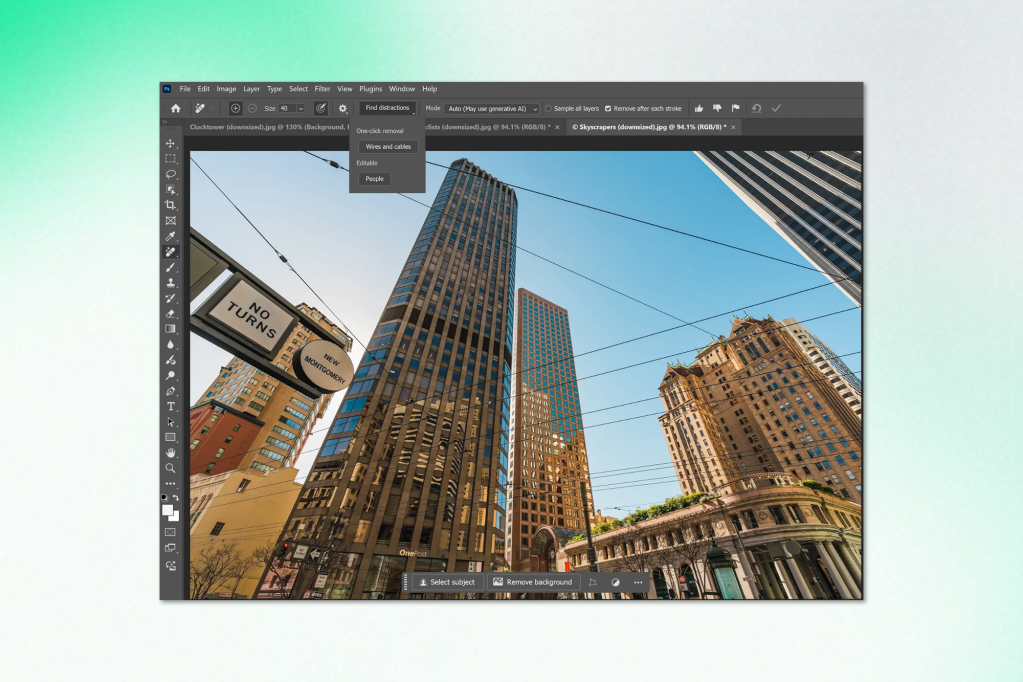 Adobe Photoshop interface showing a photograph of tall city buildings with overhead wires. A dropdown menu titled “Find distractions” appears, offering options like “One-click removal,” “Wires and cables,” and “Editable.” The interface includes familiar tools and layers panels.