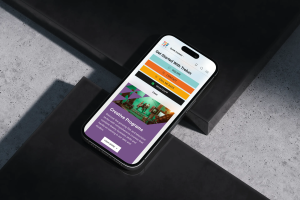 Mobile view of the Trebas Institute website on a smartphone, showcasing quick contact options and a section on Creative Programs with a vibrant photo of students in a film production studio.