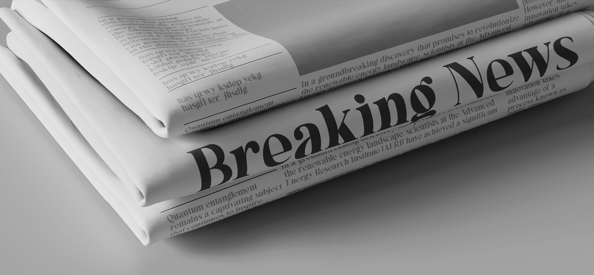 Stack of folded newspapers with the bold headline 'Breaking News' prominently displayed on the front page.