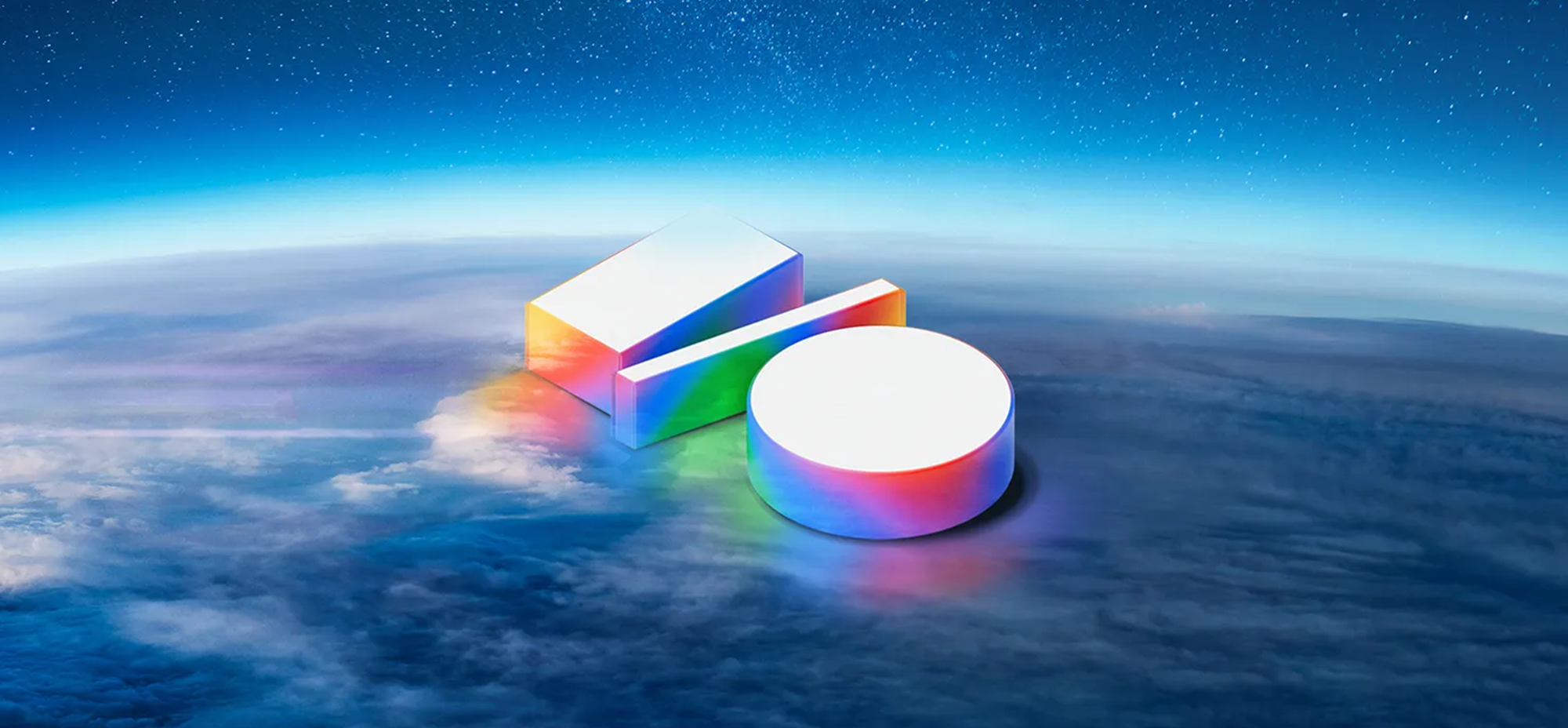 A futuristic 3D Google I/O logo floats above the Earth’s atmosphere, glowing with a multicolour gradient. The background features a layer of clouds and a star-filled sky, evoking a sense of innovation and vast potential.