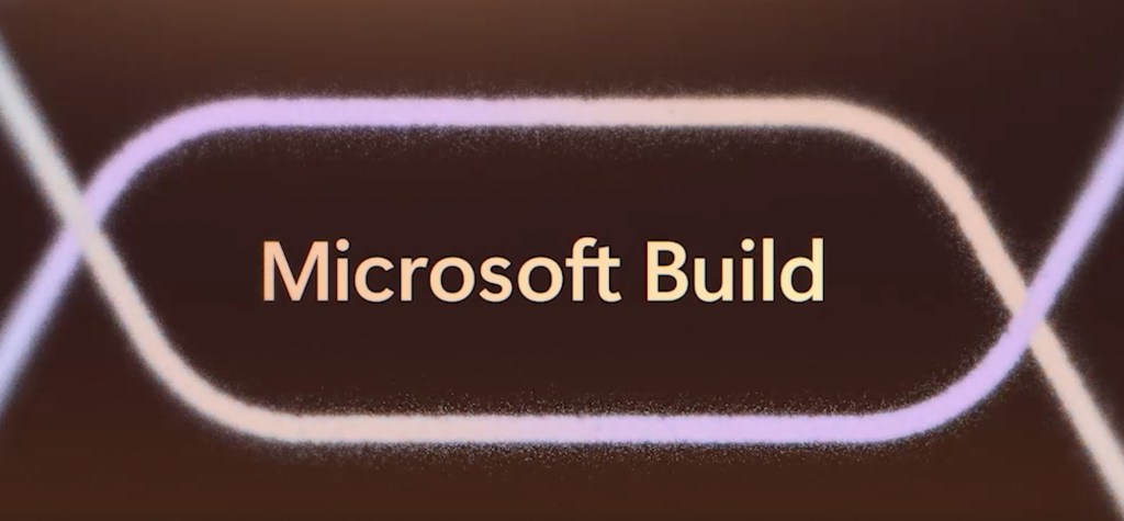Text reading "Microsoft Build" appears in soft pastel tones on a dark abstract background with flowing, glowing lines, symbolizing technology and digital transformation.
