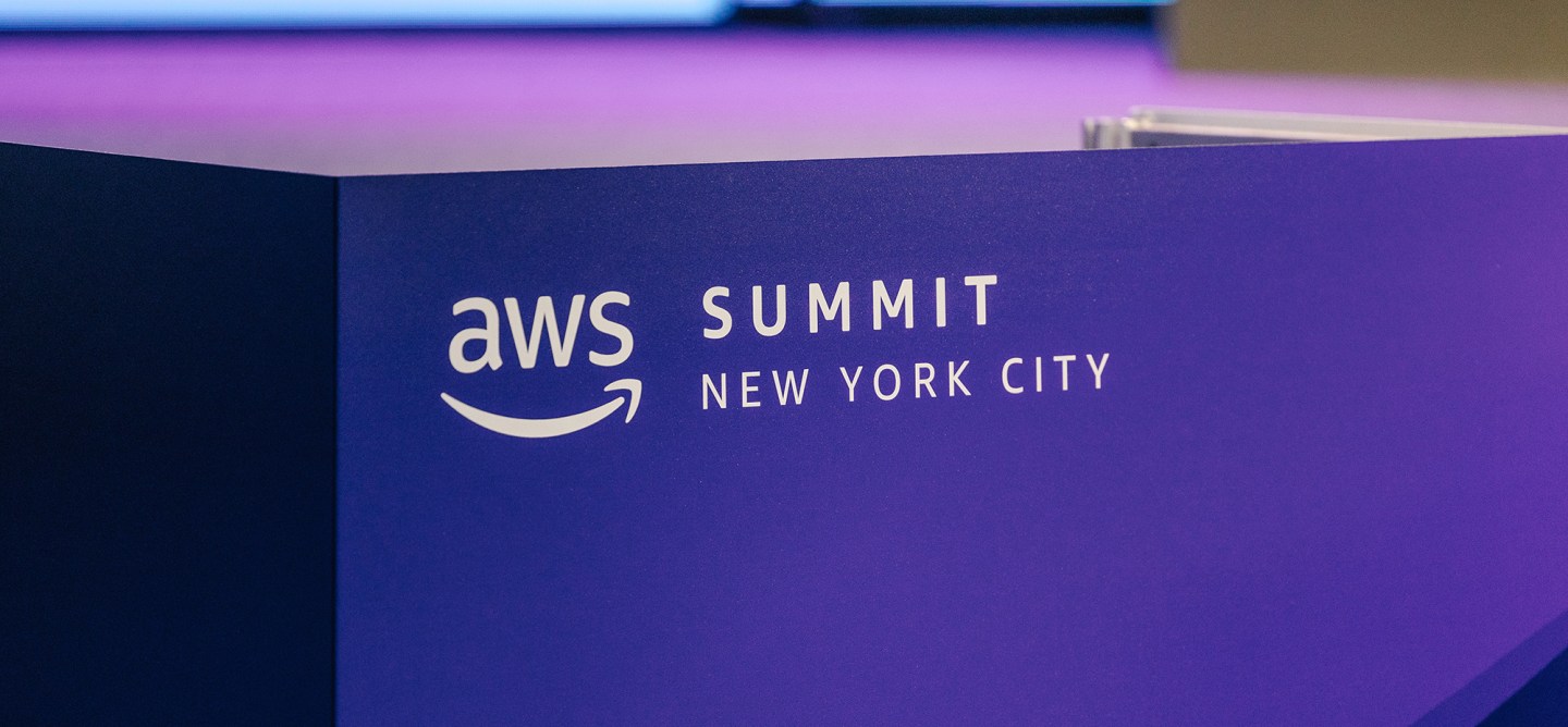 Photo of a purple sign with the AWS Summit New York City logo.