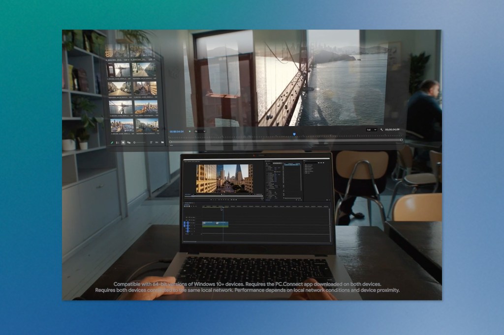 A laptop running video-editing software sits on a table while an augmented-reality display floats above it, showing additional preview windows in the room.