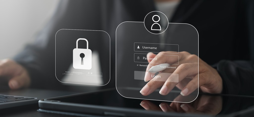 User interacting with a digital login interface displaying username and password fields alongside a security lock icon, representing secure authentication and customer identity management.