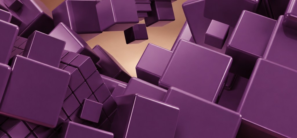 Close-up 3D rendering of interconnected purple cubes of varying sizes arranged in a modular grid, representing scalable content architecture and reusable block systems.