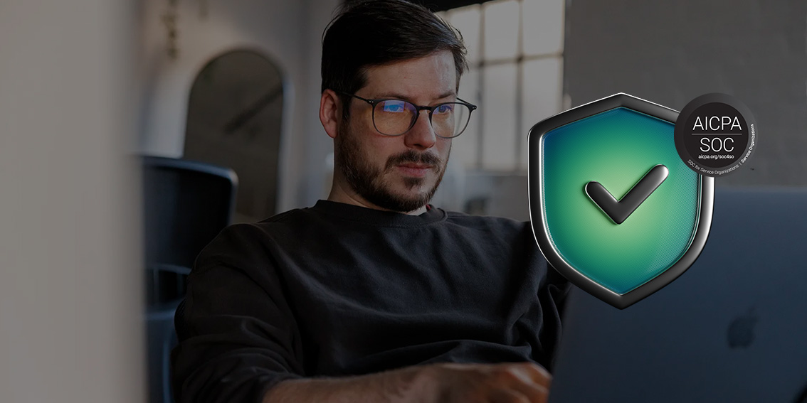 Professional using a laptop beside a SOC 2 compliance shield graphic.